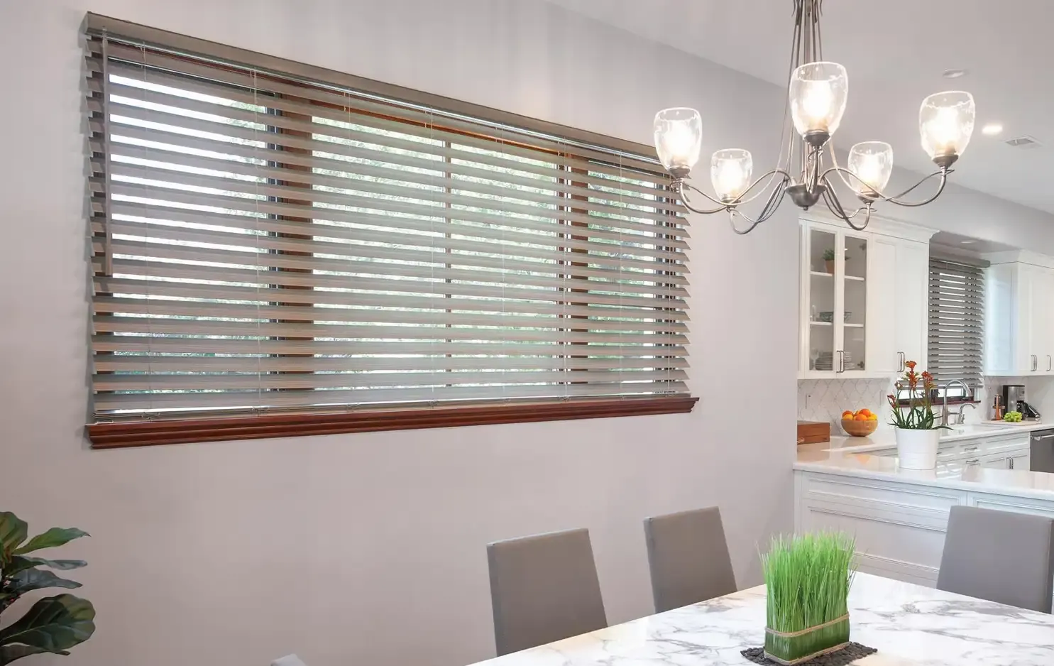 Faux-wood horizontal blinds giving a home office adjustable light control