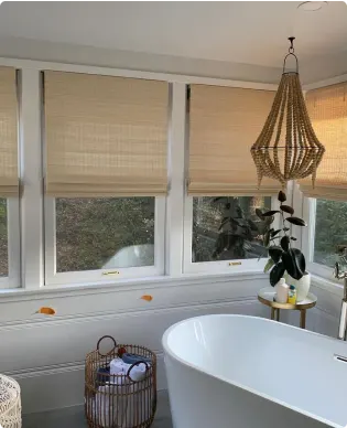 Layered window treatments across a sunlit living room
