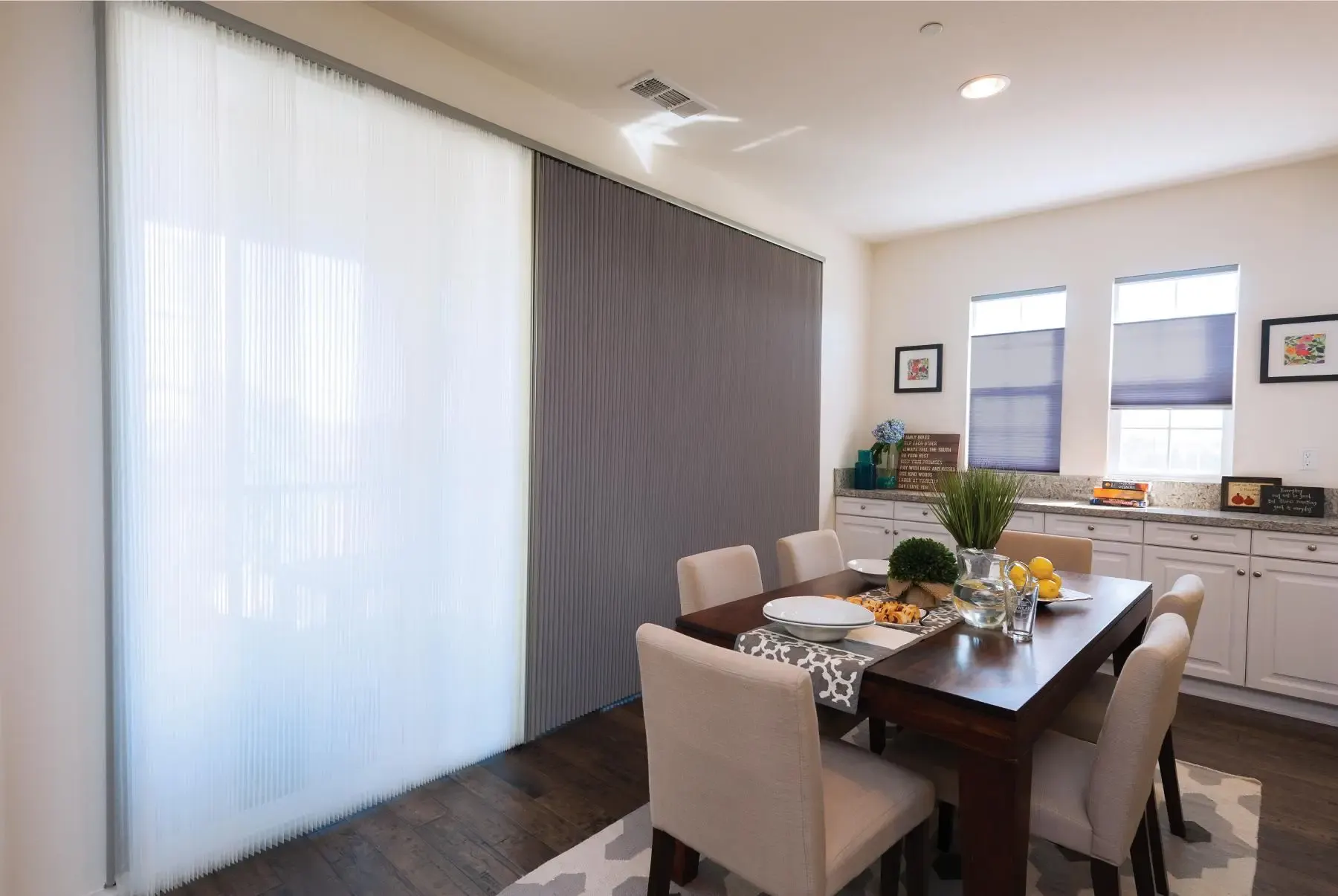 Honeycomb cellular shades covering three side-by-side bedroom windows