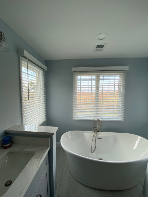 Two-window living room treatment with matching headrails and valance detail