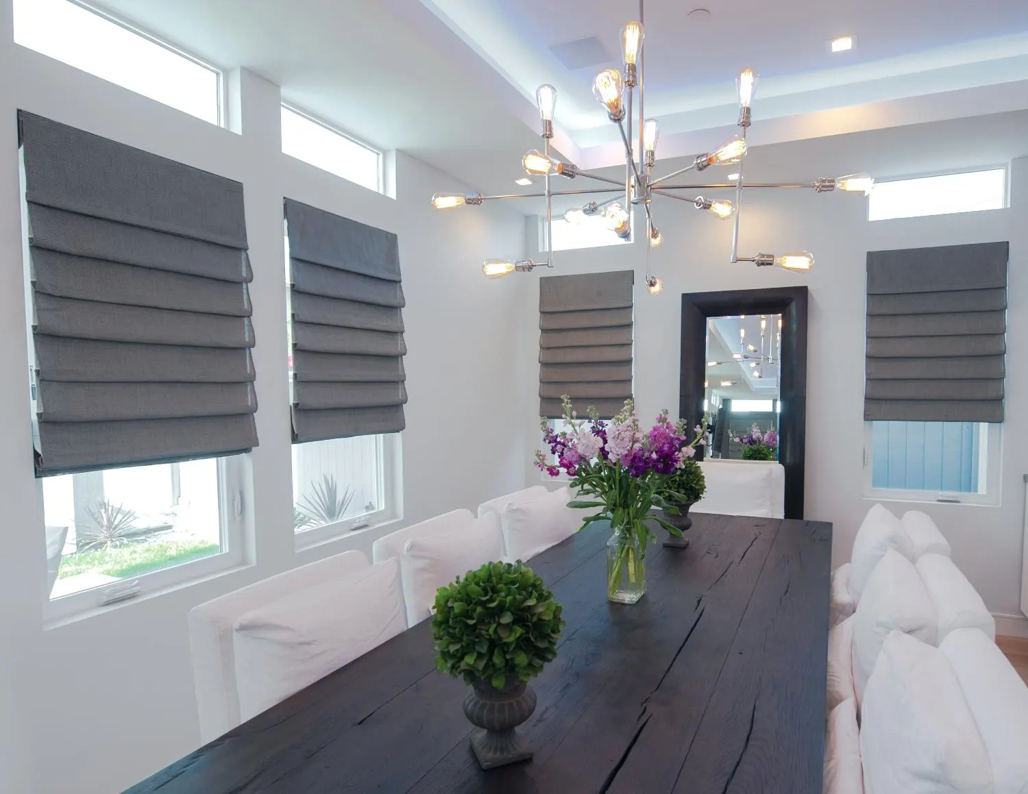 Soft white roller shades adding clean coverage in a breakfast nook